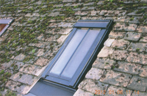 Velux windows added to roof with old stone tiles